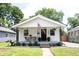Charming single-story home with front porch, American flag, and curb appeal at 4927 Caroline Ave, Indianapolis, IN 46205