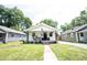 Inviting white house with a covered front porch, green lawn, and lovely curb appeal at 4927 Caroline Ave, Indianapolis, IN 46205