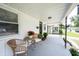 Cozy front porch with wicker furniture, potted plants, and covered ceiling at 4927 Caroline Ave, Indianapolis, IN 46205