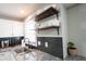 Close-up of the kitchen sink with floating shelves and dark backsplash at 4927 Caroline Ave, Indianapolis, IN 46205