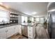 Bright open kitchen with stainless steel appliances, granite counters, and an island at 4927 Caroline Ave, Indianapolis, IN 46205
