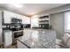 Modern kitchen with granite countertops, stainless steel appliances, and stylish backsplash at 4927 Caroline Ave, Indianapolis, IN 46205