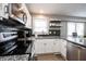 Close-up of a modern kitchen with granite counters and stainless steel microwave at 4927 Caroline Ave, Indianapolis, IN 46205