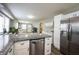 Bright kitchen with stainless steel fridge and an island with granite counters at 4927 Caroline Ave, Indianapolis, IN 46205