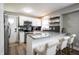 Bright kitchen with bar seating, stainless steel appliances and granite countertops at 4927 Caroline Ave, Indianapolis, IN 46205