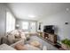Cozy living room showcasing a neutral sectional, stylish rug, and media console at 4927 Caroline Ave, Indianapolis, IN 46205