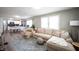 Comfortable living room with a large sectional, rug, and open view to the kitchen at 4927 Caroline Ave, Indianapolis, IN 46205
