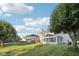 Large backyard with a well-maintained lawn, mature trees and a deck with an umbrella at 5269 Deer Creek Dr, Indianapolis, IN 46254