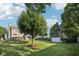 Expansive backyard with a deck, shed, mature trees, and lush green grass, ideal for recreation at 5269 Deer Creek Dr, Indianapolis, IN 46254