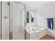 Bathroom showcasing a shower and a bathtub with a window at 5269 Deer Creek Dr, Indianapolis, IN 46254