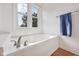 Bathroom featuring a bathtub and a window at 5269 Deer Creek Dr, Indianapolis, IN 46254