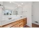 Bathroom featuring double sinks and vanity with wood cabinets, and a large mirror at 5269 Deer Creek Dr, Indianapolis, IN 46254