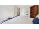 Light bedroom featuring neutral carpeting, a mirrored door and a bookshelf at 5269 Deer Creek Dr, Indianapolis, IN 46254