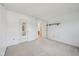 Bright bedroom with neutral carpeting, featuring a door and a shelf for added storage at 5269 Deer Creek Dr, Indianapolis, IN 46254