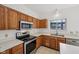 Modern kitchen with wood cabinets, stainless steel appliances, and white countertops, offering a functional layout at 5269 Deer Creek Dr, Indianapolis, IN 46254