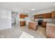 Spacious kitchen featuring wood cabinets, a kitchen island, and tile flooring at 5269 Deer Creek Dr, Indianapolis, IN 46254