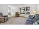 Bright living room with large windows, plush carpeting and comfortable seating at 5269 Deer Creek Dr, Indianapolis, IN 46254
