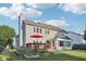 The home has a wooden deck, sunroom addition and raised garden beds in the lush lawn at 5269 Deer Creek Dr, Indianapolis, IN 46254