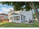 Back of house featuring a sun room addition overlooking a well-maintained yard with a deck at 5269 Deer Creek Dr, Indianapolis, IN 46254