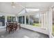 Bright sunroom featuring large windows, a dining table, and views of the backyard, perfect for entertaining at 5269 Deer Creek Dr, Indianapolis, IN 46254