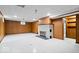 Finished basement with paneled walls, tile floors, fireplace, and a storage room, perfect for recreation at 5460 N Park Dr, Indianapolis, IN 46220