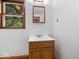 Bathroom vanity with wood cabinet and a window bringing in natural light at 5460 N Park Dr, Indianapolis, IN 46220