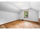 Attic bedroom featuring hardwood floors and a window providing natural light at 5460 N Park Dr, Indianapolis, IN 46220