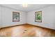 Bright bedroom featuring hardwood floors and two windows providing natural light at 5460 N Park Dr, Indianapolis, IN 46220