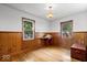 Bedroom featuring charming wood-paneled walls and hardwood floors at 5460 N Park Dr, Indianapolis, IN 46220