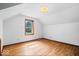 Attic bedroom featuring hardwood floors and a window providing natural light at 5460 N Park Dr, Indianapolis, IN 46220