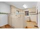 Functional kitchen with ample cabinetry and laminate floors at 5460 N Park Dr, Indianapolis, IN 46220