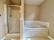 Bathroom with a glass-enclosed shower and a white soaking tub, perfect for relaxation at 5571 Auburndale Dr, Bargersville, IN 46106