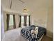 Bedroom with carpet, ceiling light, three windows, and a wrought iron queen-size bed at 5571 Auburndale Dr, Bargersville, IN 46106