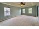 Spacious bedroom with carpet, tray ceiling, ceiling fan, and three windows providing plenty of natural light at 5571 Auburndale Dr, Bargersville, IN 46106
