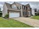 Brick and siding home featuring an attached garage and a concrete driveway at 5571 Auburndale Dr, Bargersville, IN 46106