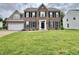 Traditional two-story brick home with a well-manicured lawn and attached two-car garage at 5571 Auburndale Dr, Bargersville, IN 46106