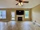 Bright living room featuring modern floors, a fireplace, a ceiling fan, and natural light at 5571 Auburndale Dr, Bargersville, IN 46106