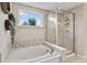 This bathroom boasts a soaking tub, separate walk-in shower, and a window for natural light at 5917 Bartley Dr, Noblesville, IN 46062