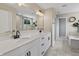 Bright bathroom featuring double sinks, quartz countertop, a soaking tub, and separate shower with modern fixtures at 5917 Bartley Dr, Noblesville, IN 46062