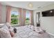 Light and airy bedroom with three windows, pink accents, neutral walls, and carpet floors throughout at 5917 Bartley Dr, Noblesville, IN 46062