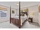 Charming bedroom with dark wood four poster bed, neutral walls, and sunny windows at 5917 Bartley Dr, Noblesville, IN 46062