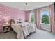 Bedroom with pink accent wall, pink curtains, and a decorative light fixture, filled with natural light at 5917 Bartley Dr, Noblesville, IN 46062