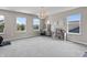 Expansive bonus room with plenty of natural light, carpet and exercise equipment at 5917 Bartley Dr, Noblesville, IN 46062