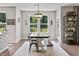 Dining area with large windows, modern light fixture, and an adjacent doorway at 5917 Bartley Dr, Noblesville, IN 46062