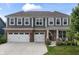 Charming two-story home with a brick and gray facade, three-car garage, and well-manicured lawn at 5917 Bartley Dr, Noblesville, IN 46062