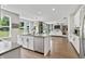 Bright, open kitchen features an island with seating and stainless steel appliances overlooking the living area at 5917 Bartley Dr, Noblesville, IN 46062