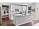 Kitchen island with white cabinetry, stainless steel appliances and modern fixtures at 5917 Bartley Dr, Noblesville, IN 46062