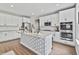 Bright kitchen with large island, white cabinetry, stainless steel appliances, and dark countertop at 5917 Bartley Dr, Noblesville, IN 46062