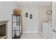 Well-organized laundry room with washer, shelving, ironing board, and stylish geometric wallpaper at 5917 Bartley Dr, Noblesville, IN 46062