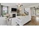 Inviting living room featuring a fireplace, stairs to the second floor, and lots of natural light at 5917 Bartley Dr, Noblesville, IN 46062